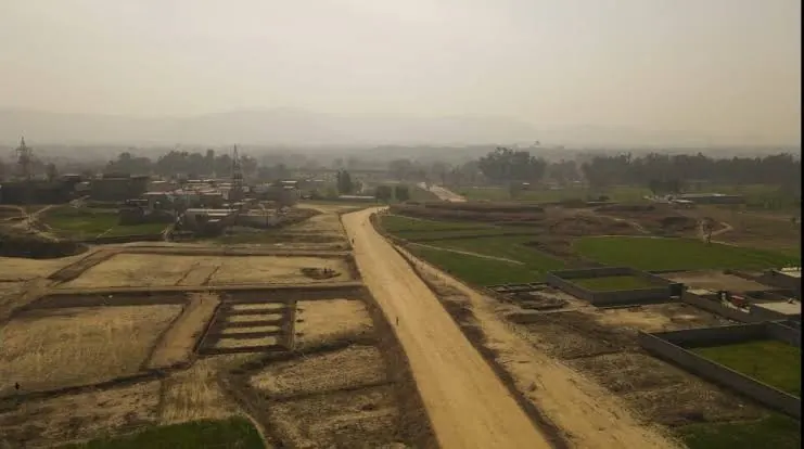 Aerial view of demarcated plots and the main access road at Shaheen Enclave Burhan